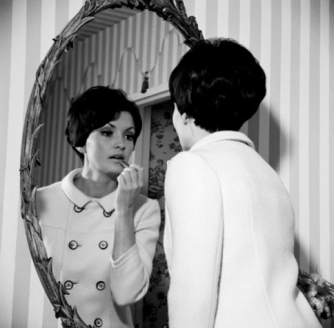 Young woman putting make-up on in front of mirror Canvas Art - (18 x 24)