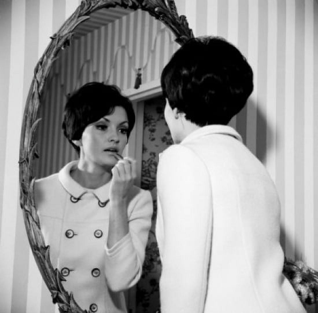Young woman putting make-up on in front of mirror Canvas Art -  (24 x 36)