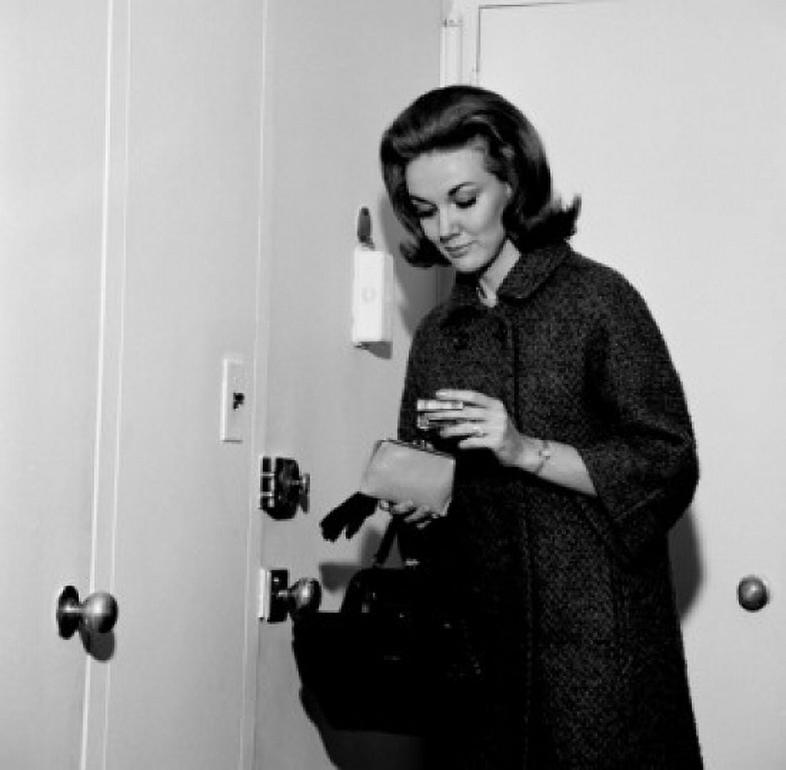 Young woman putting money into purse before leaving house Canvas Art - (18 x 24)