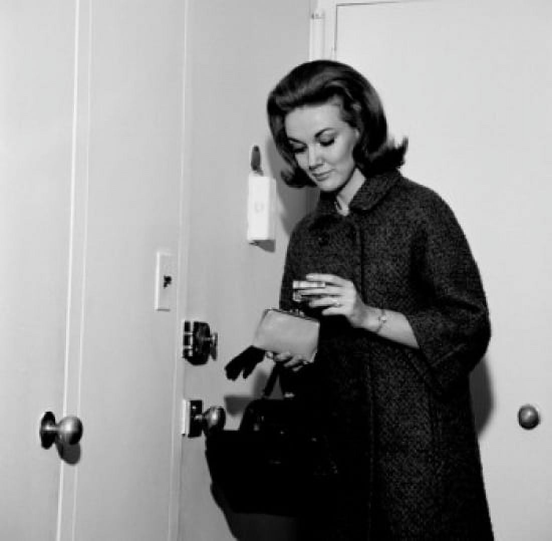 Young woman putting money into purse before leaving house Canvas Art - (24 x 36)