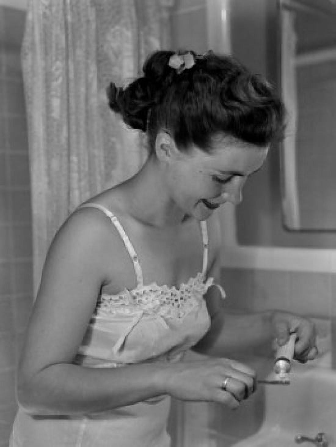 Young woman putting toothpaste on tooth brush Canvas Art - (24 x 36)