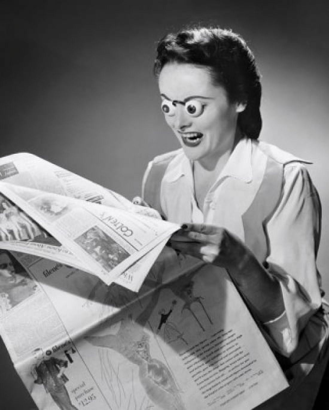 Young woman reading a newspaper with her eyes popping out Canvas Art - (18 x 24)