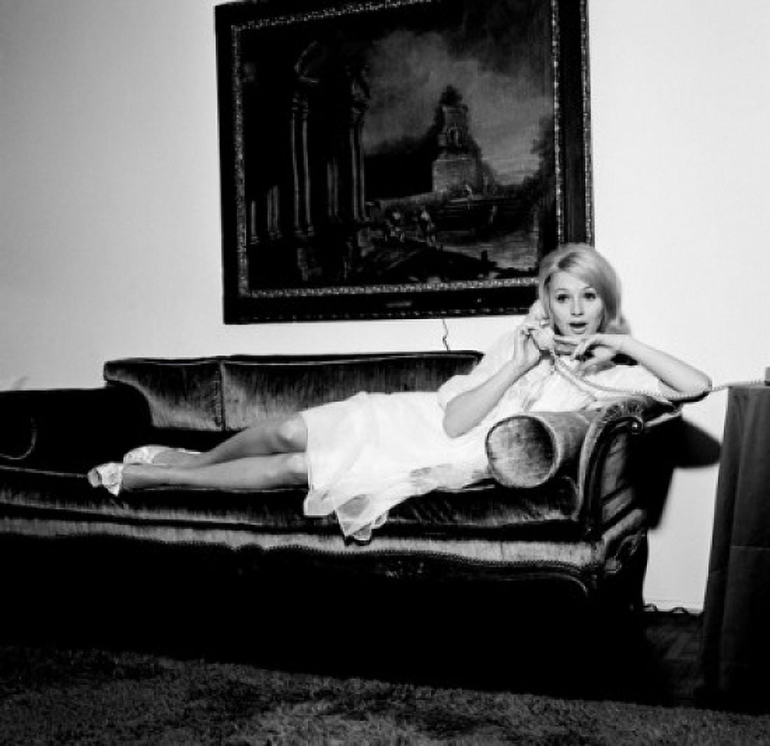 Young woman reclining on sofa using telephone Canvas Art -  (24 x 36)