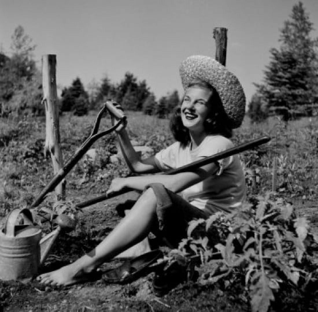 Young woman resting in farm field Canvas Art - (24 x 36)