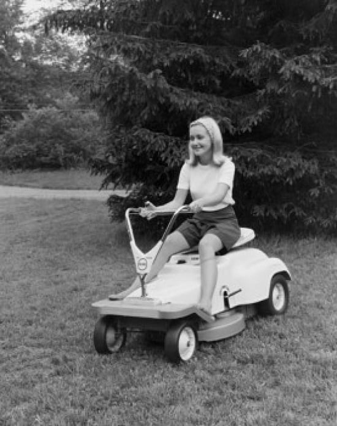 Young woman riding a lawn mower Canvas Art - (24 x 36)