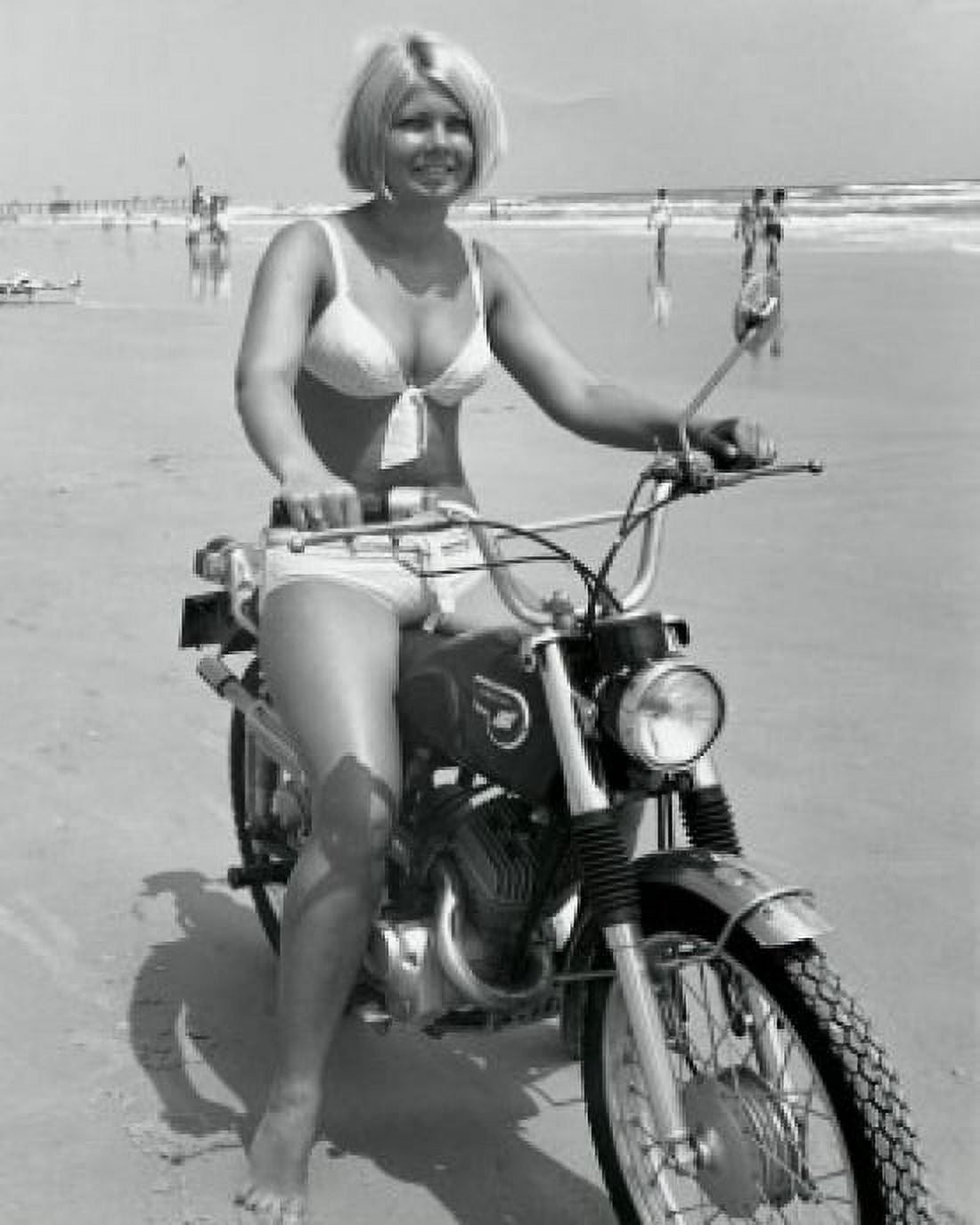 Young woman riding motorcycle on beach Canvas Art - (18 x 24)