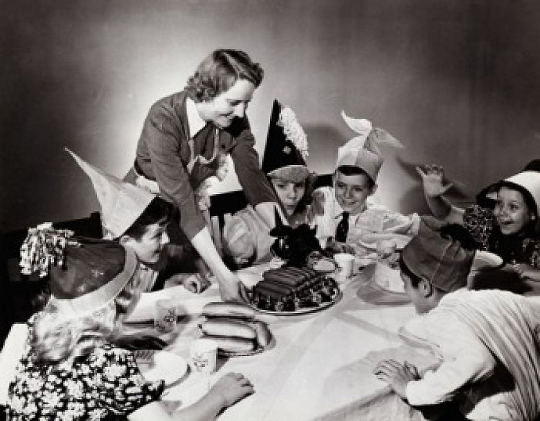 Young woman serving hot dogs to children at a party Canvas Art - (18 x 24)