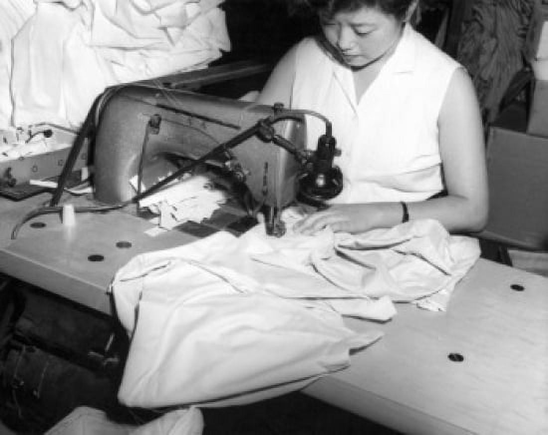 Young woman sewing in a textile factory Canvas Art - (24 x 36)