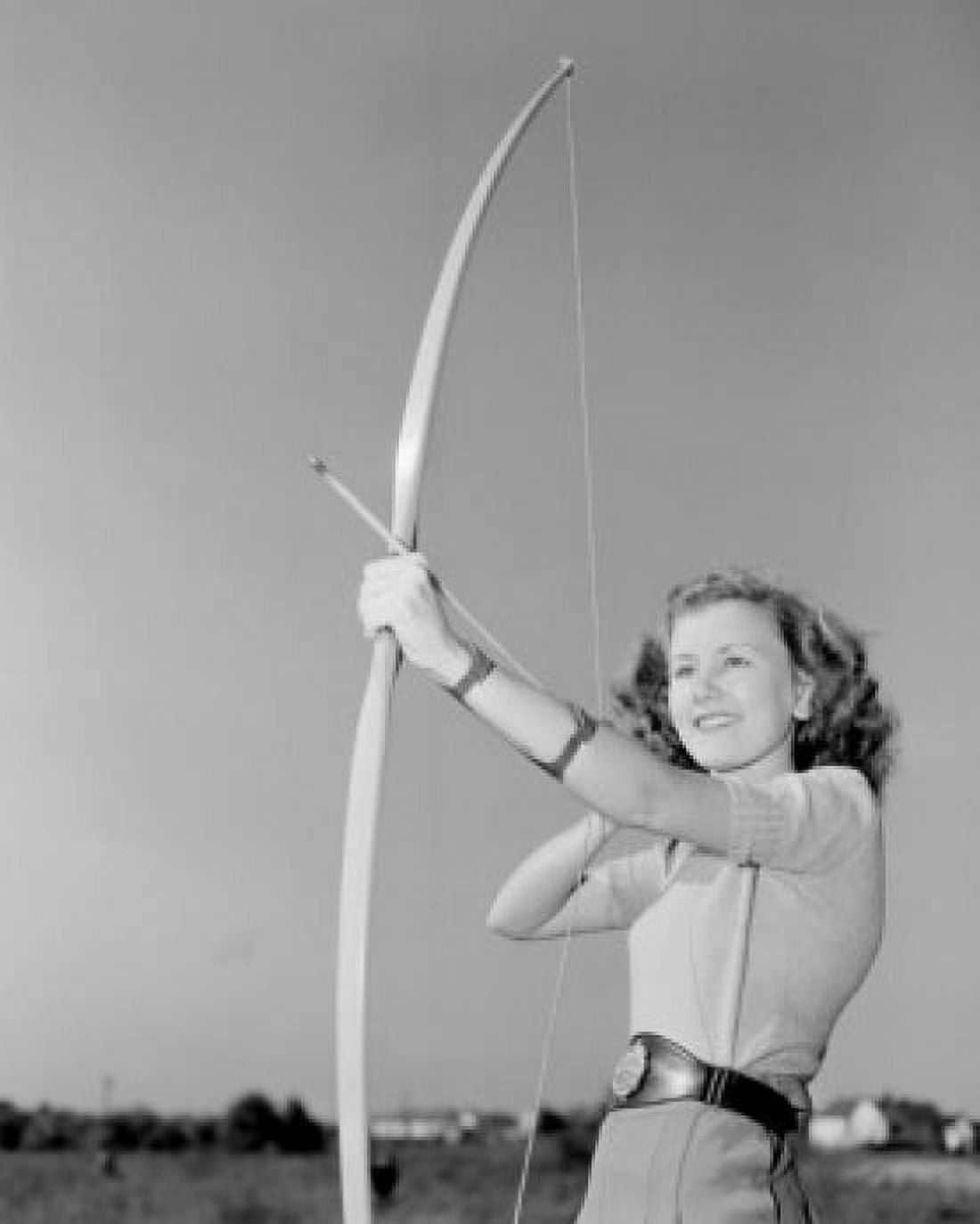 Young woman shooting with bow Canvas Art - (18 x 24)
