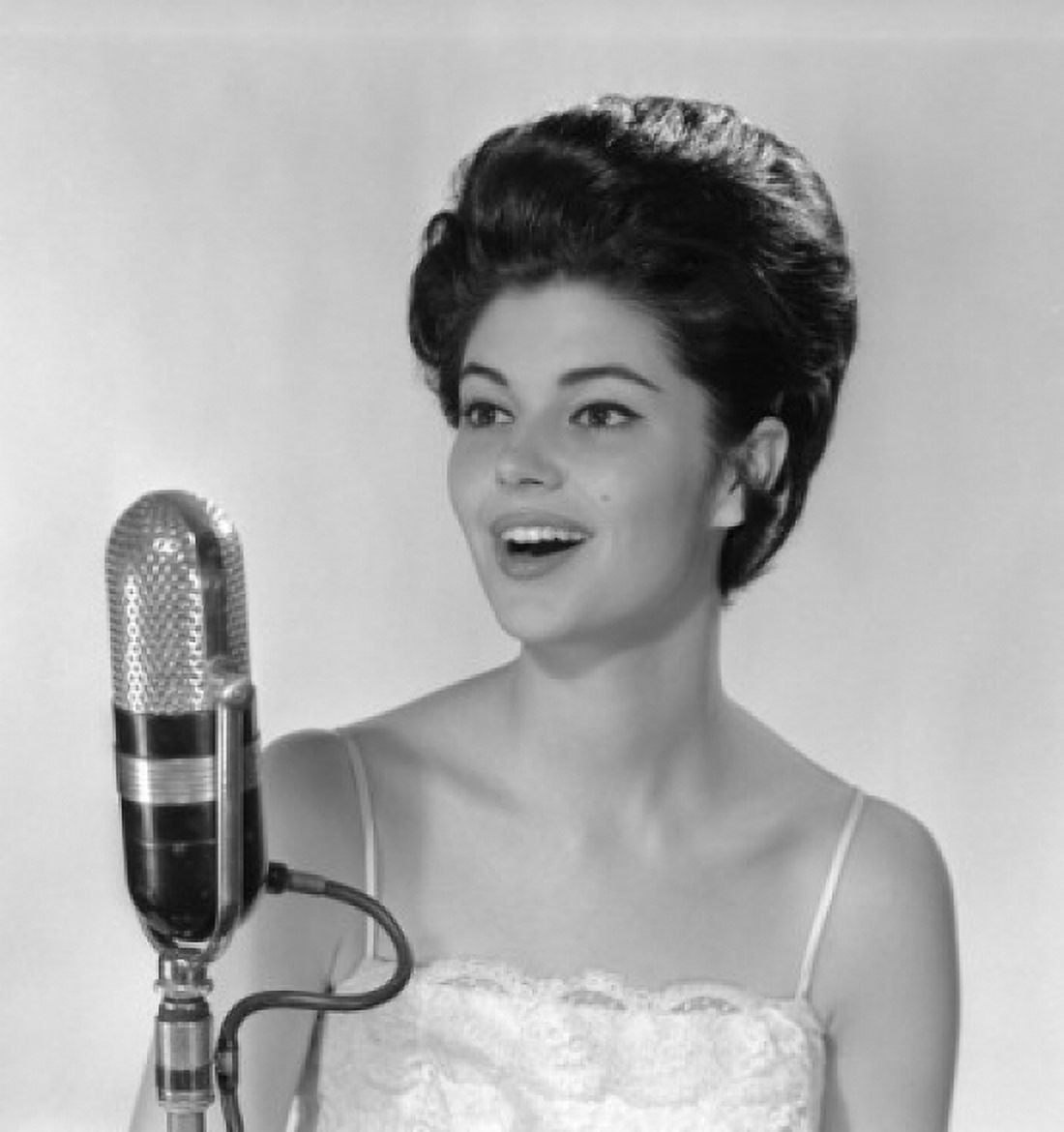 Young woman singing into microphone Canvas Art - (24 x 36)