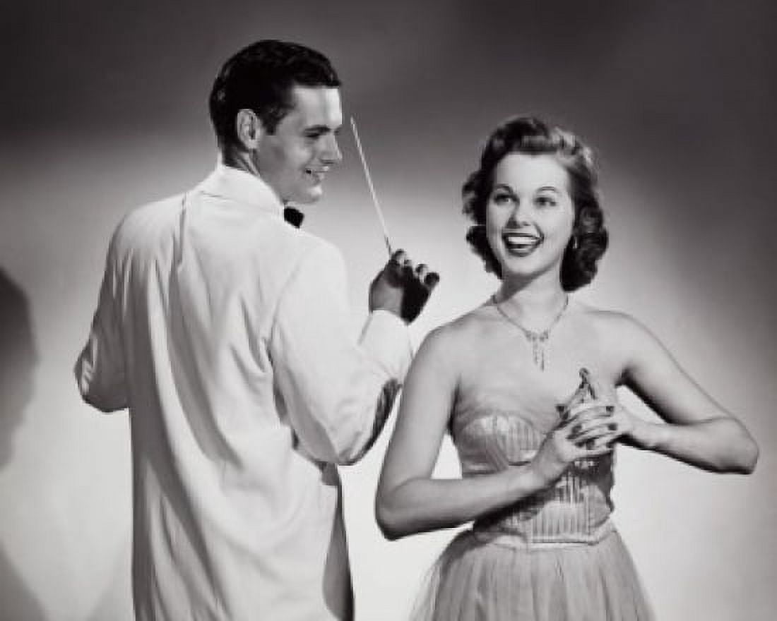 Young woman singing with a music conductor holding a conductors baton behind her Canvas Art - (18 x 24)