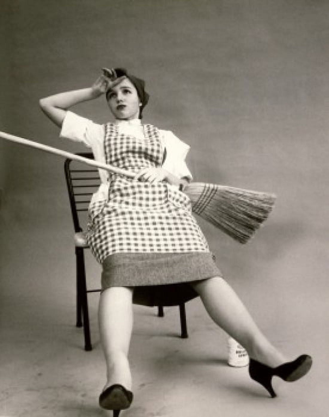 Young woman sitting in a chair holding a broom Canvas Art - (18 x 24)