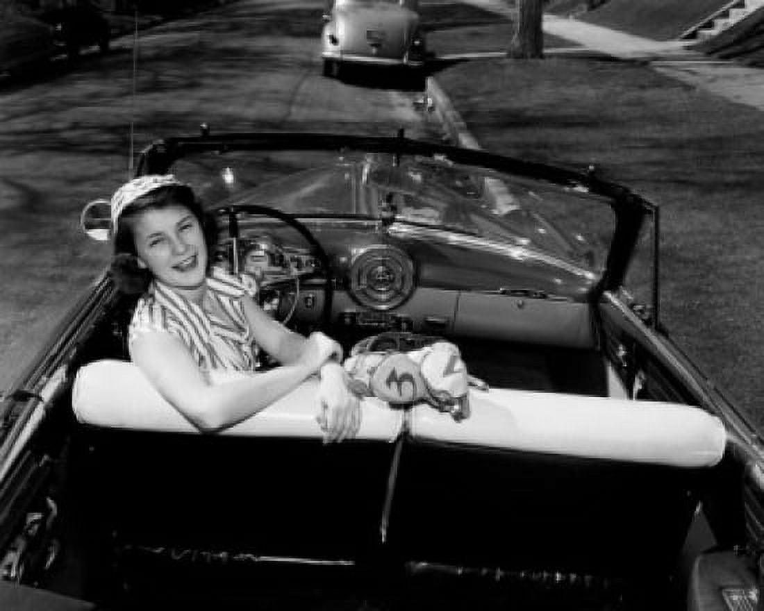 Young woman sitting in car with golf bag Canvas Art - (24 x 36)