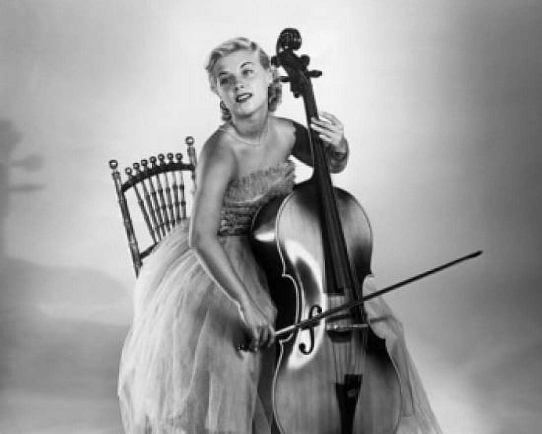 Young woman sitting on a chair and playing a cello Canvas Art - (18 x 24)