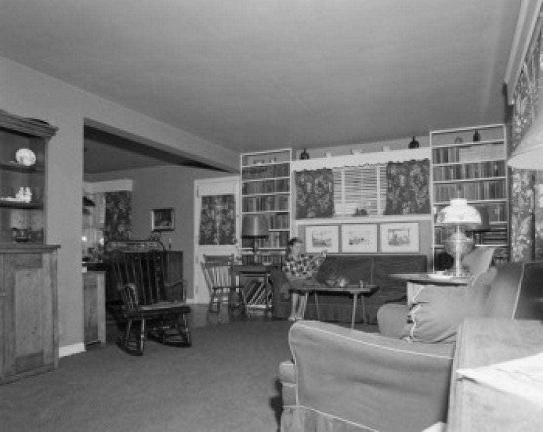 Young woman sitting on a couch reading a magazine Canvas Art - (18 x 24)
