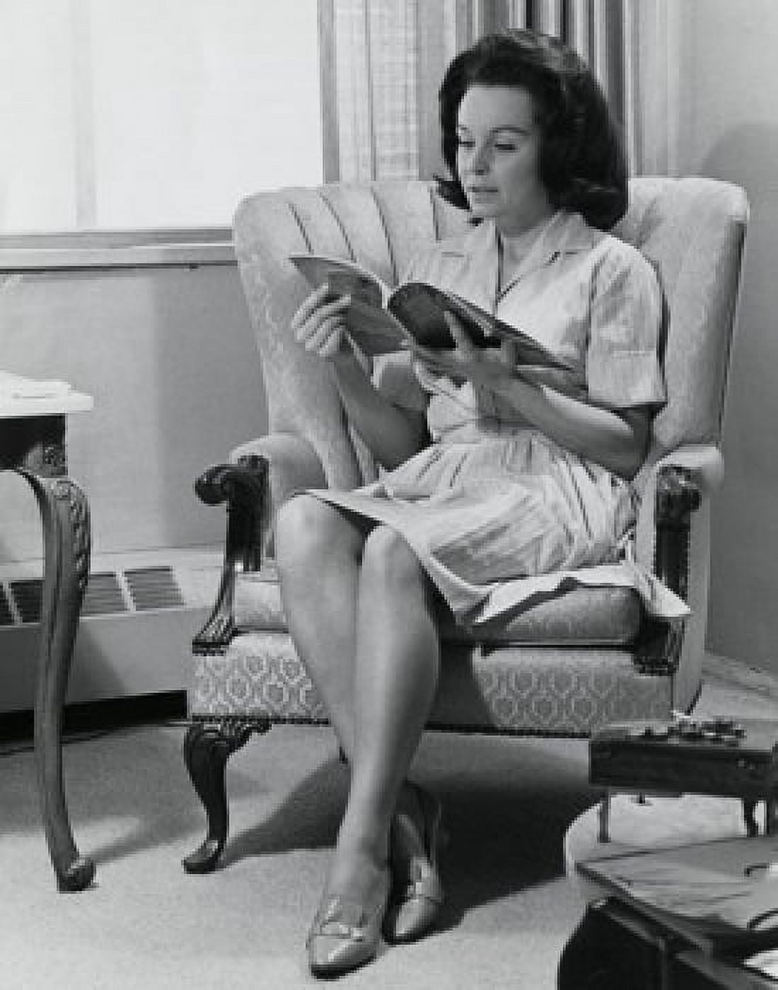 Young woman sitting on an armchair reading a magazine Canvas Art - (24 x 36)