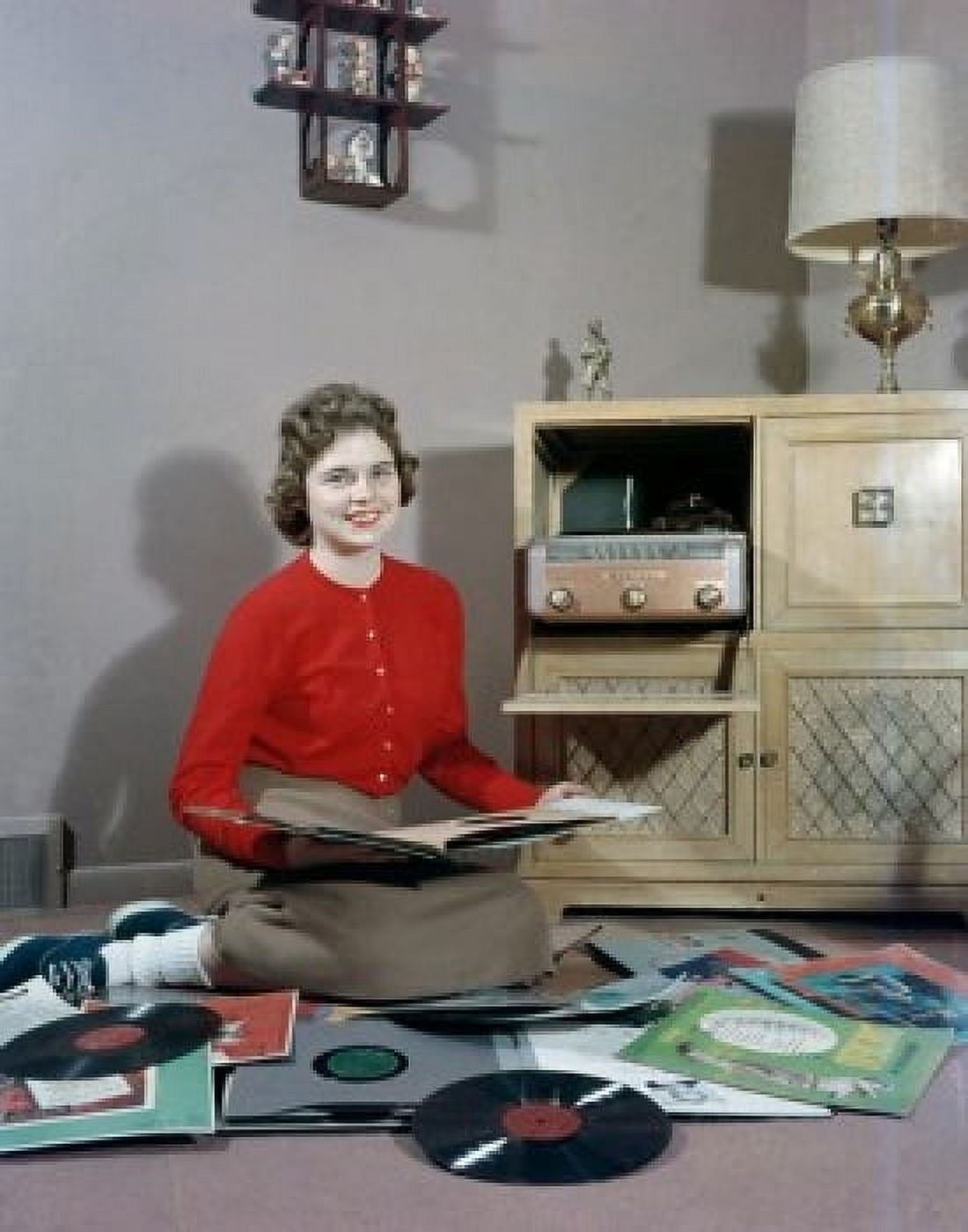 Young woman sitting on floor and choosing vinyl records Canvas Art - (24 x 36)