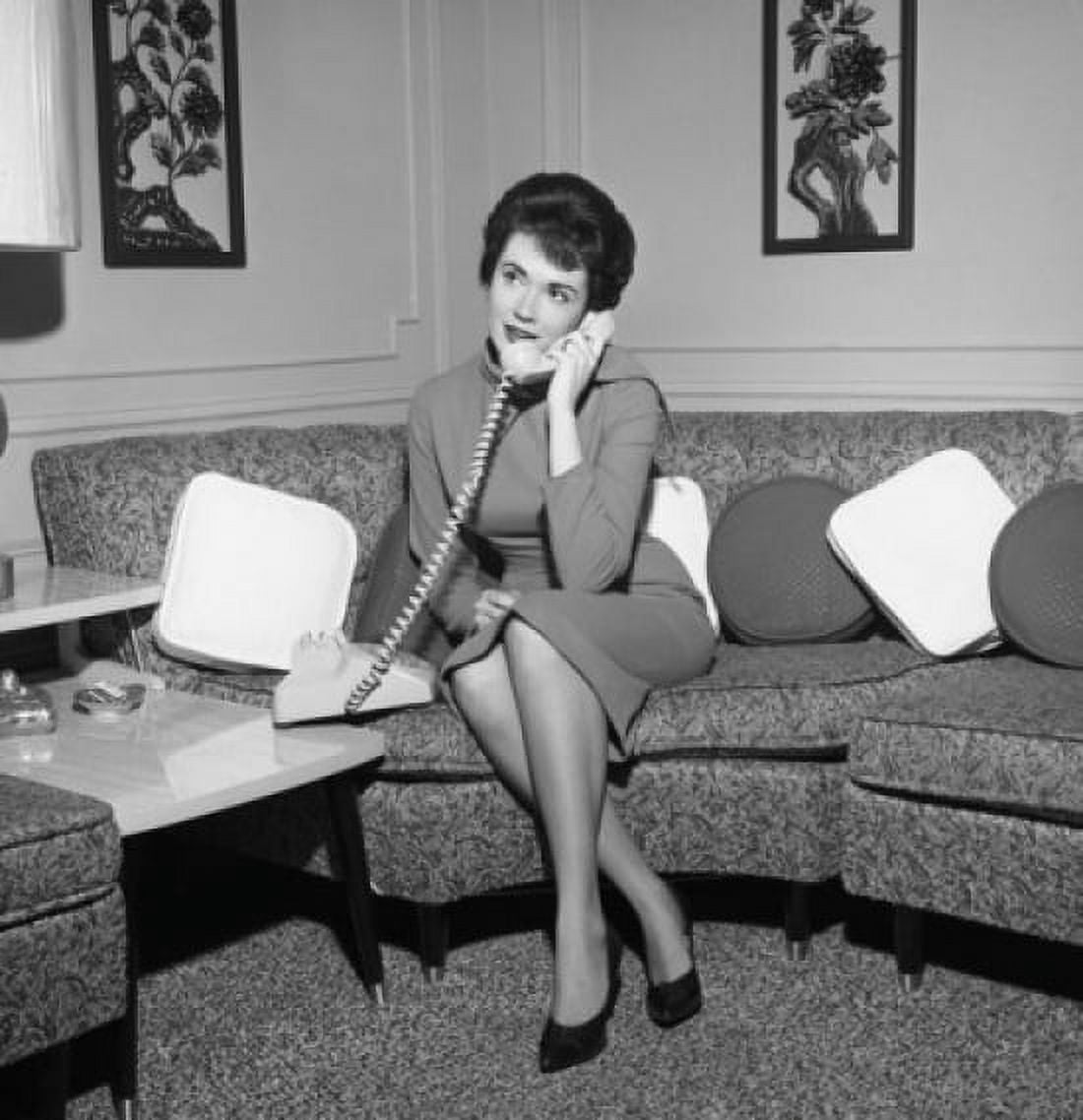 Young woman sitting on sofa and talking on the phone Canvas Art - (18 x 24)