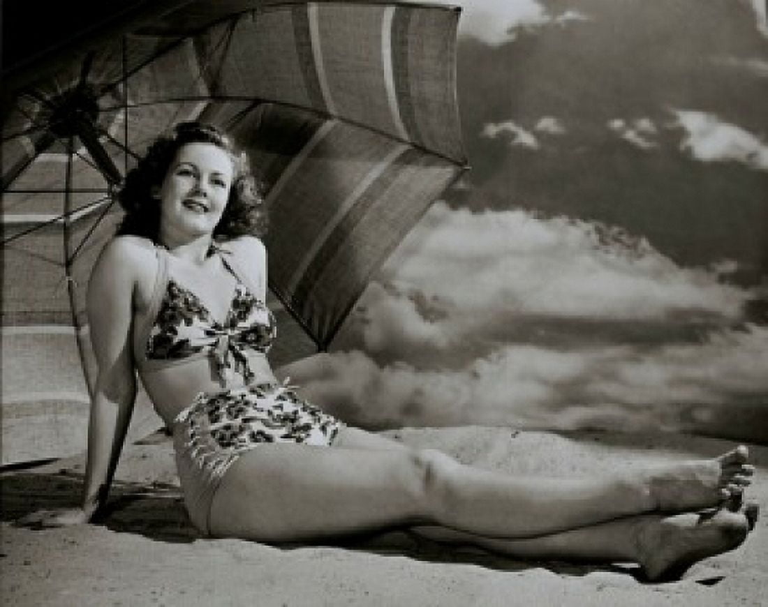 Young woman sitting on the beach Canvas Art - (18 x 24)