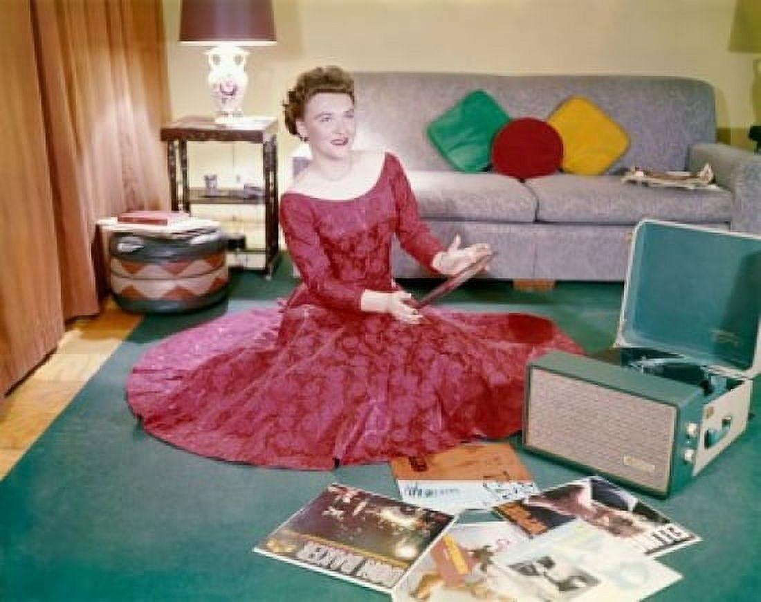 Young woman sitting on the floor holding a record Canvas Art - (18 x 24)
