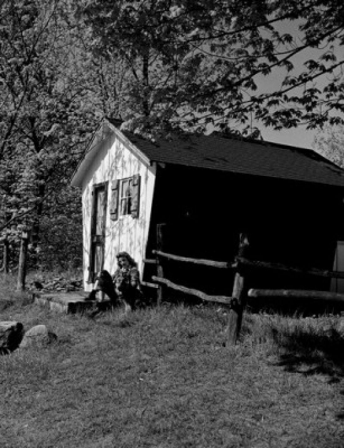 Young woman sitting outside shed Canvas Art - (24 x 36)