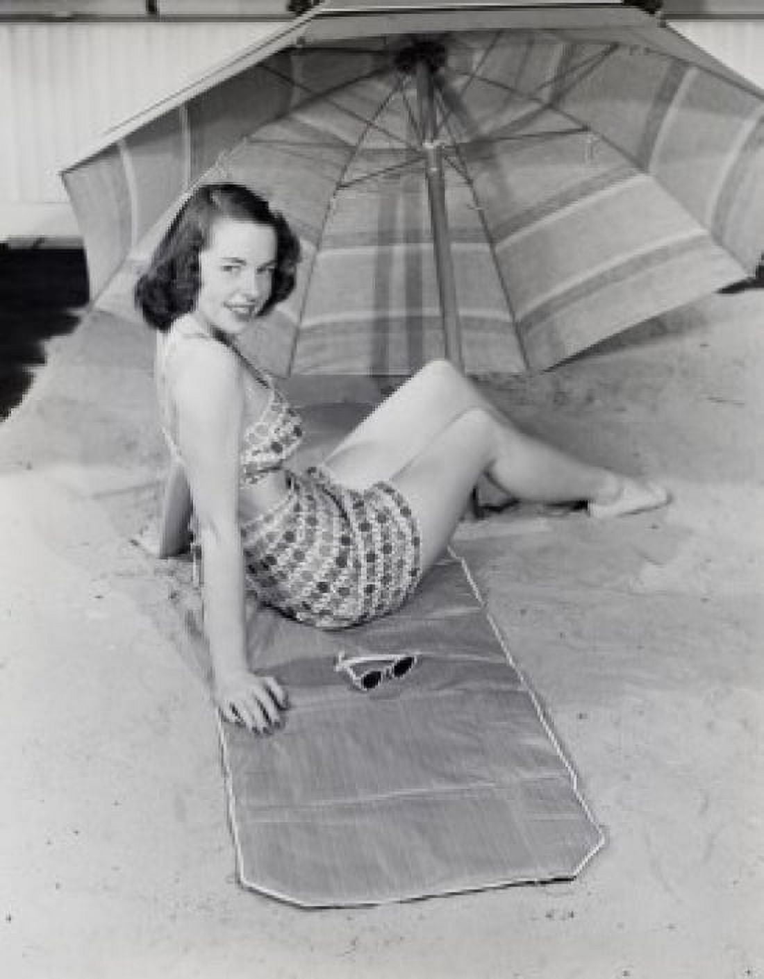 Young woman sitting under beach umbrella Canvas Art - (18 x 24)