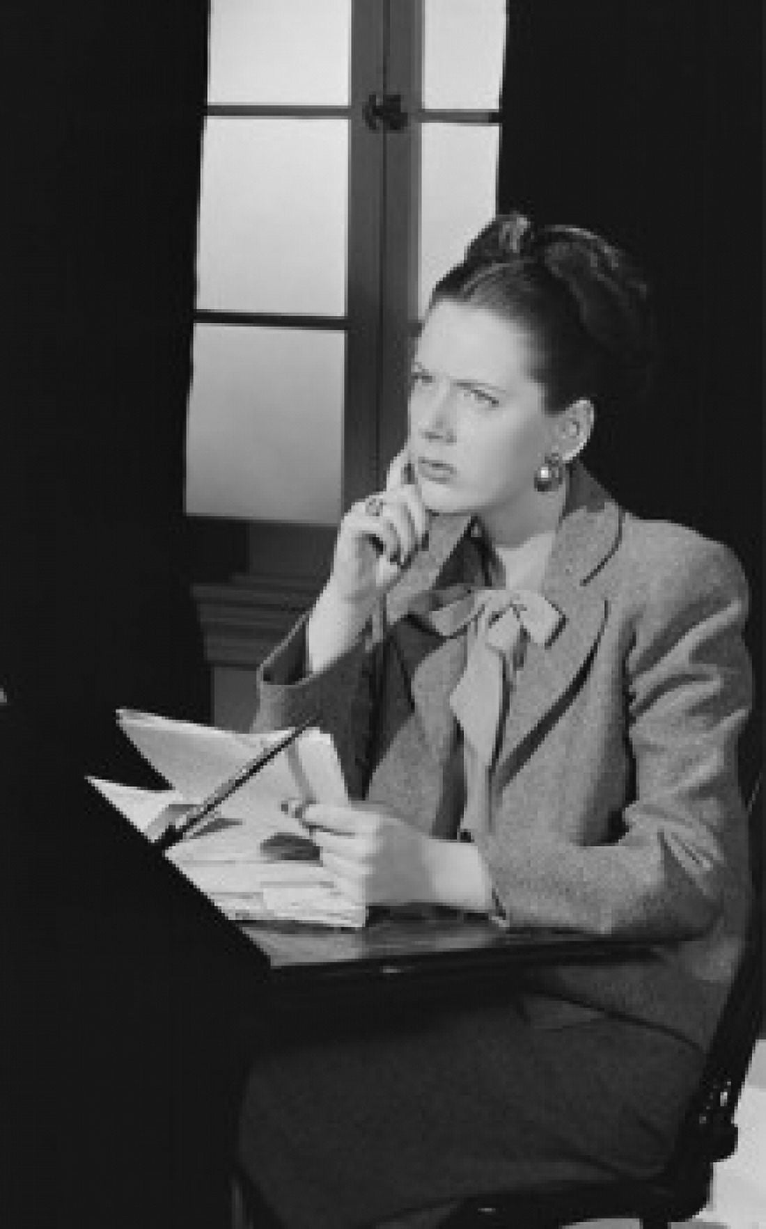 Young woman sorting by desk with documents and thinking Canvas Art - (18 x 24)