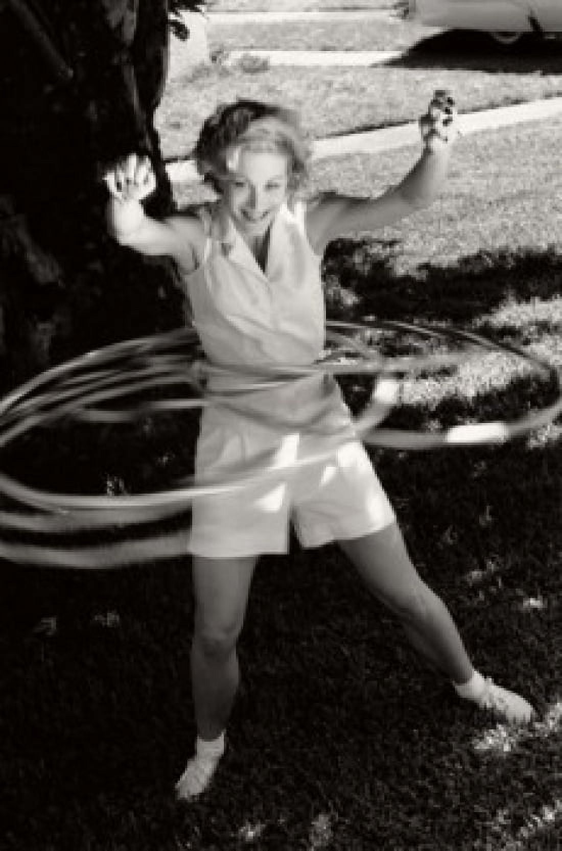 Young woman spinning hula hoops Canvas Art - (18 x 24)