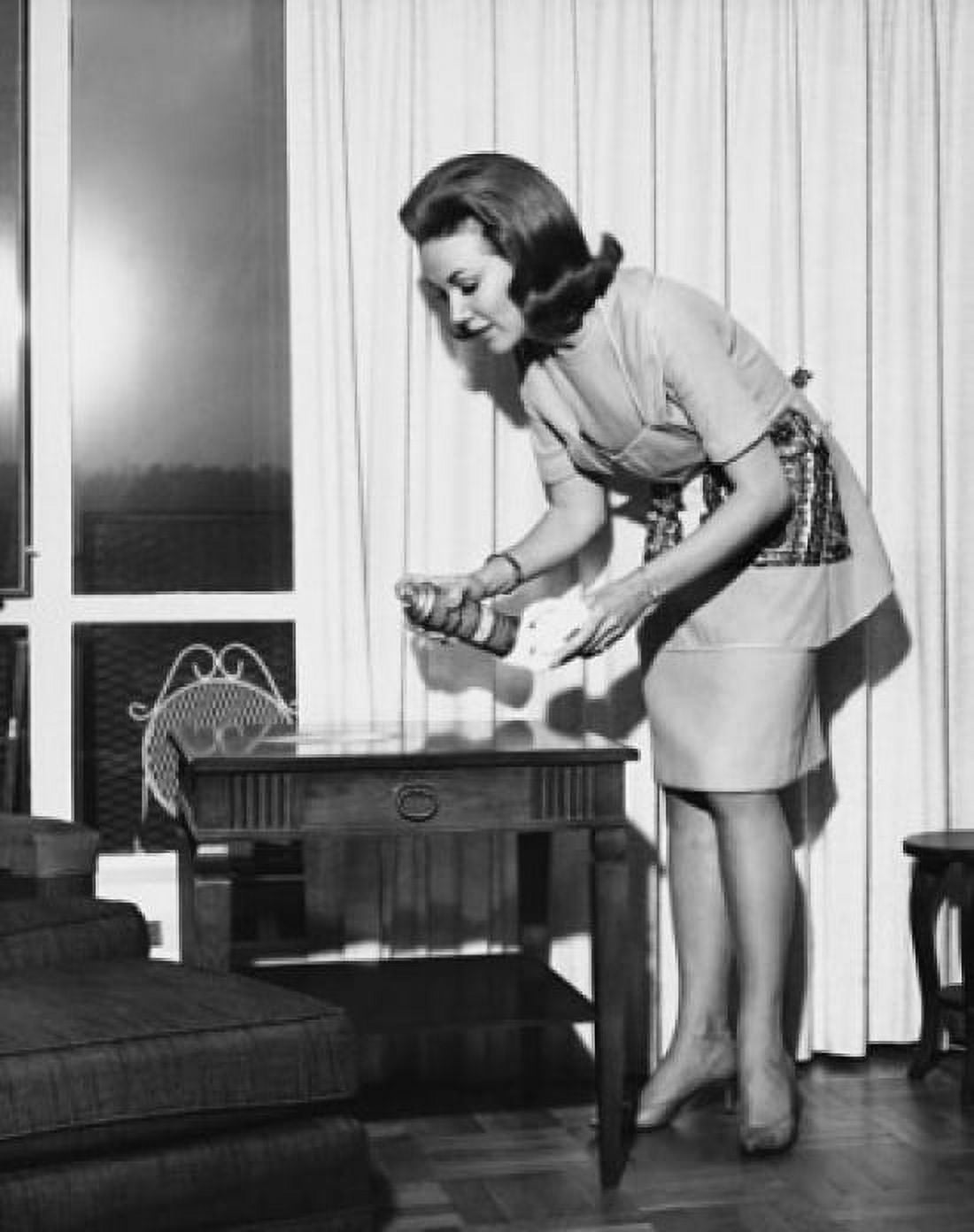 Young woman spraying furniture polish on a table Canvas Art - (18 x 24)