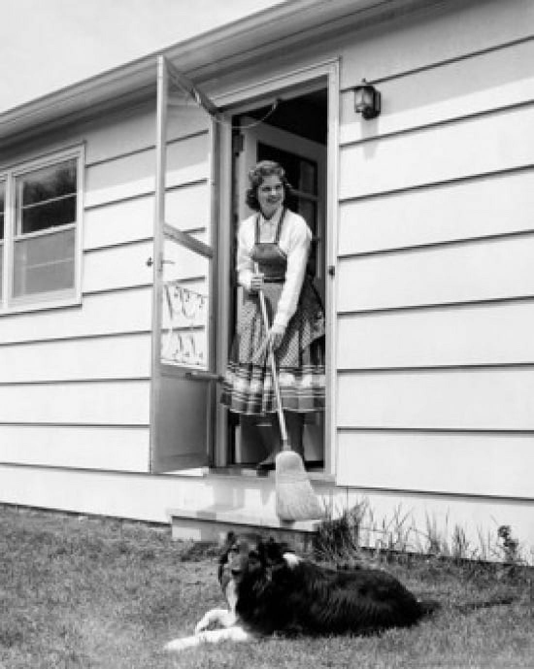 Young woman standing at the doorstep holding a broom stick Canvas Art - (18 x 24)
