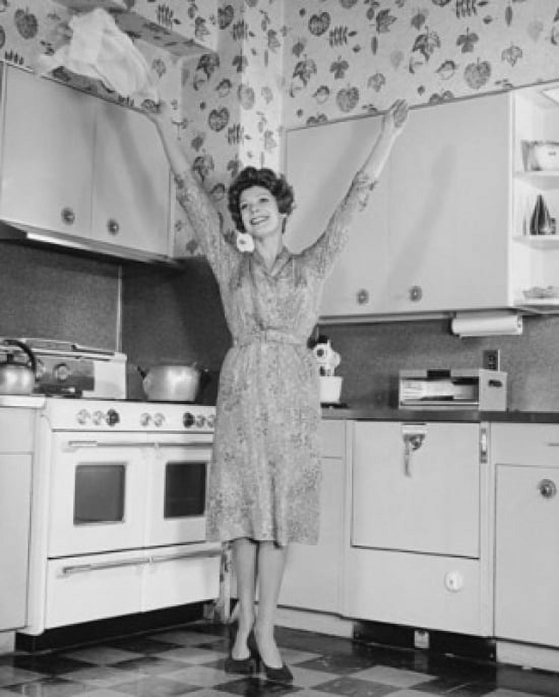 Young woman standing in a kitchen with her arms raised Canvas Art - (18 x 24)