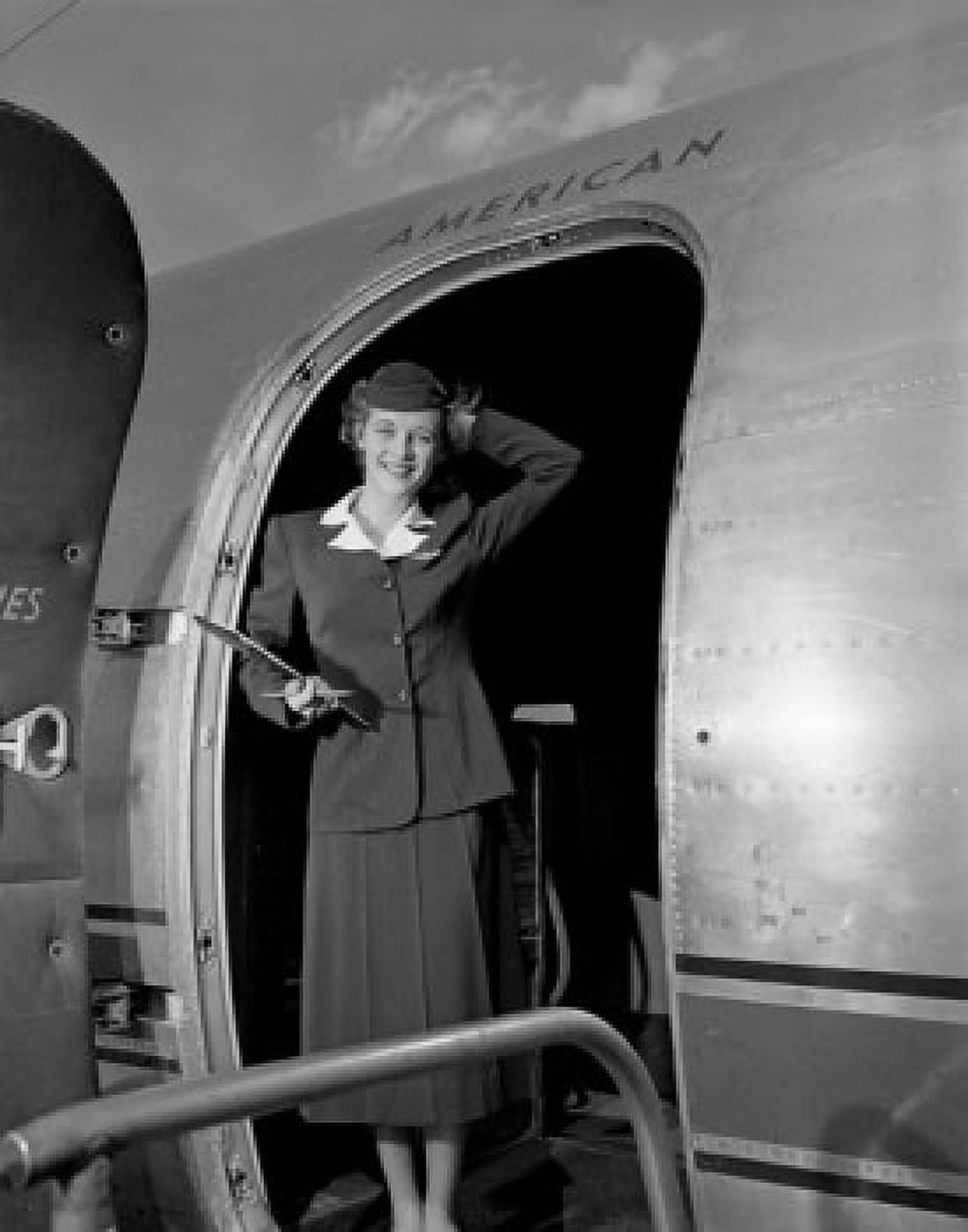 Young woman standing in aiplane door and smiling Canvas Art - (18 x 24)