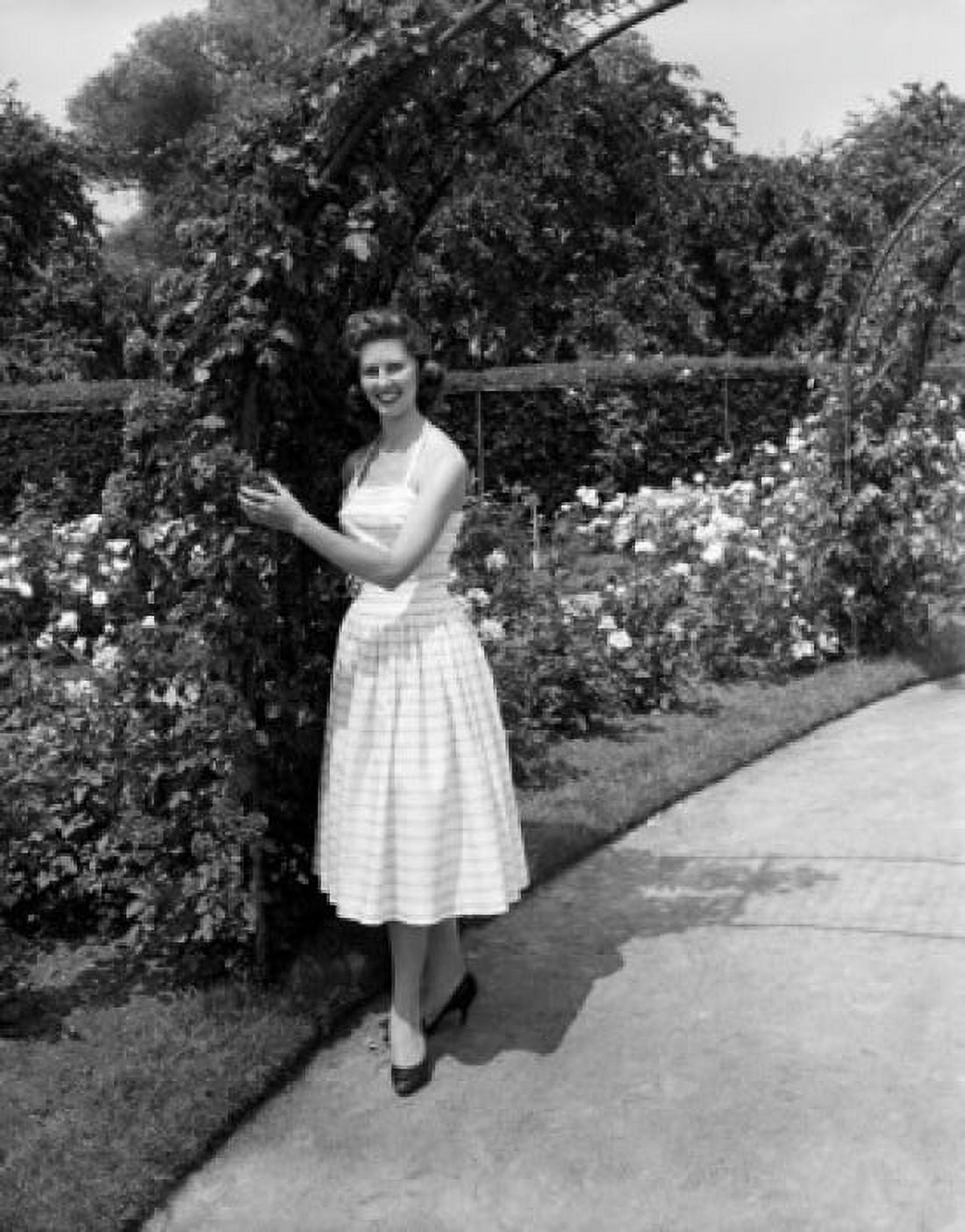 Young woman standing in rose garden Canvas Art - (24 x 36)