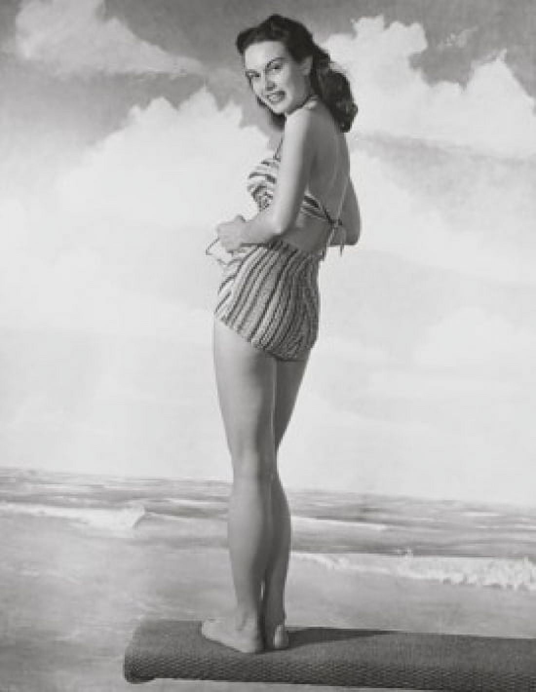 Young woman standing on a beach mat and smiling Canvas Art - (18 x 24)