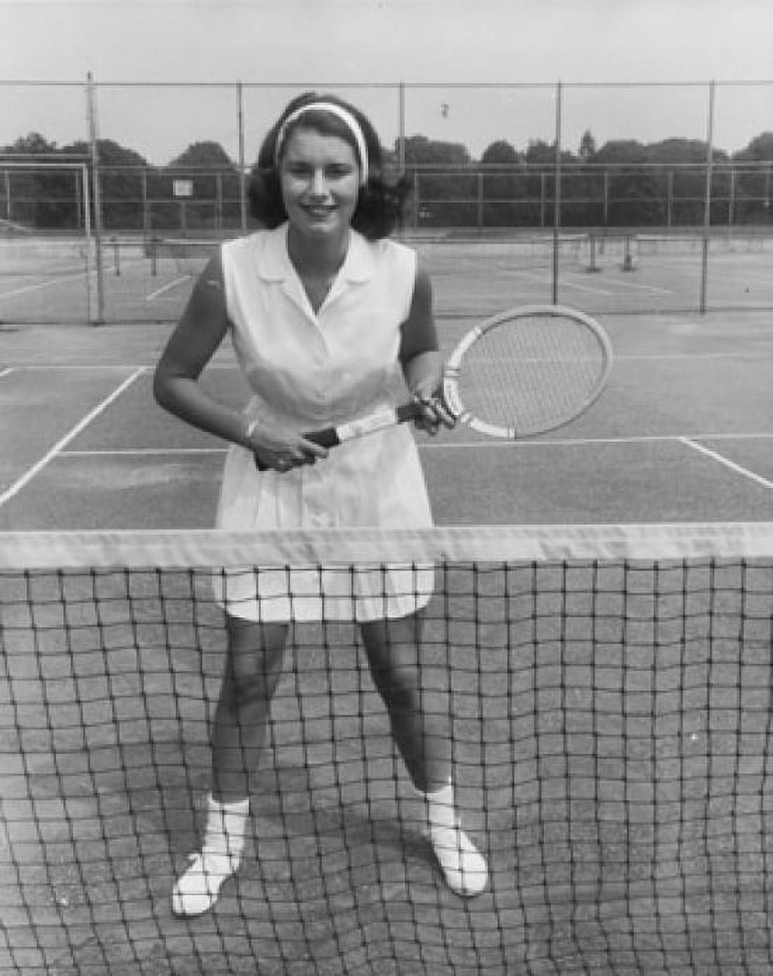 Young woman standing on a tennis court and holding a tennis racket Canvas Art - (18 x 24)