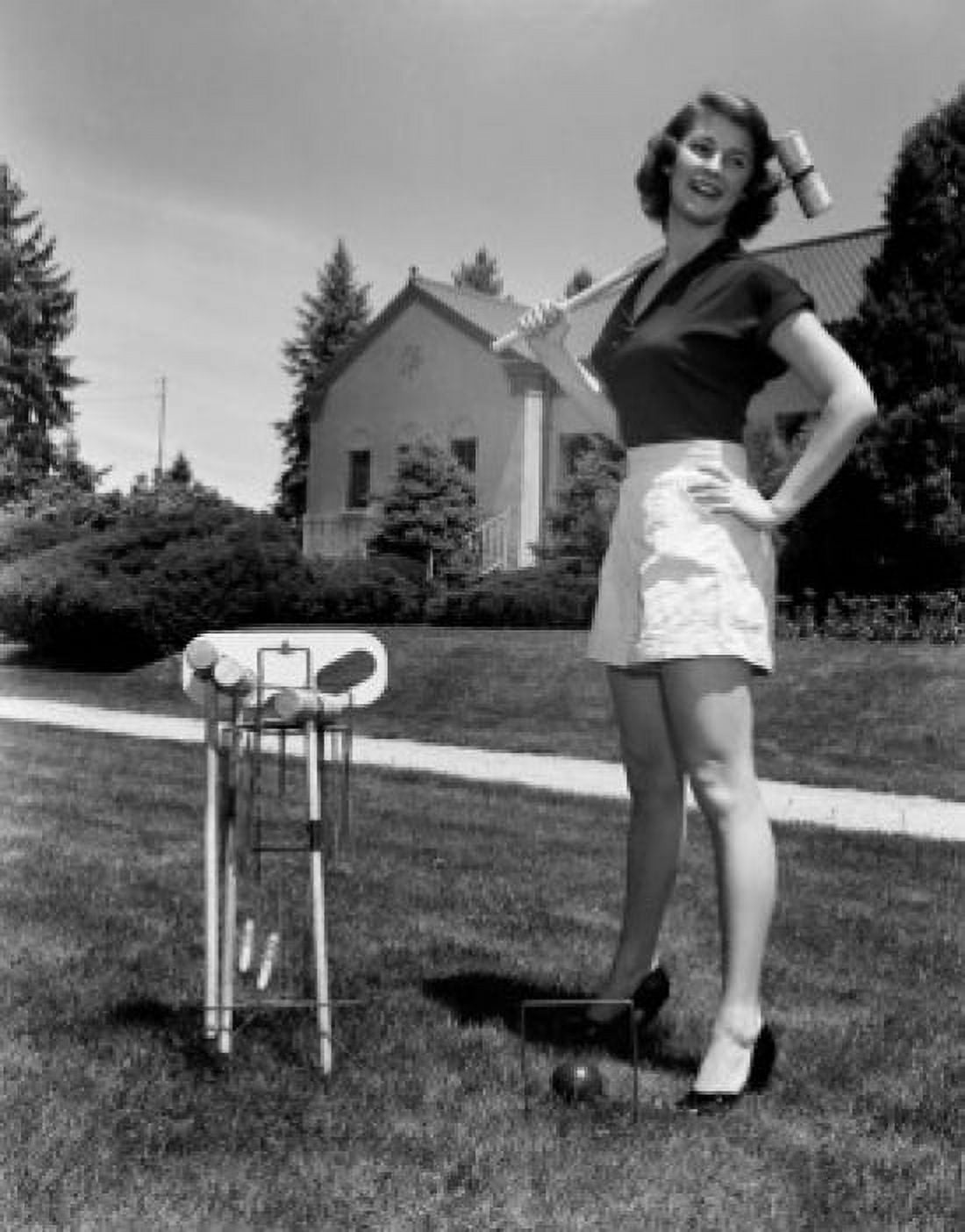 Young woman standing on lawn holding croquet mallet Canvas Art - (18 x 24)