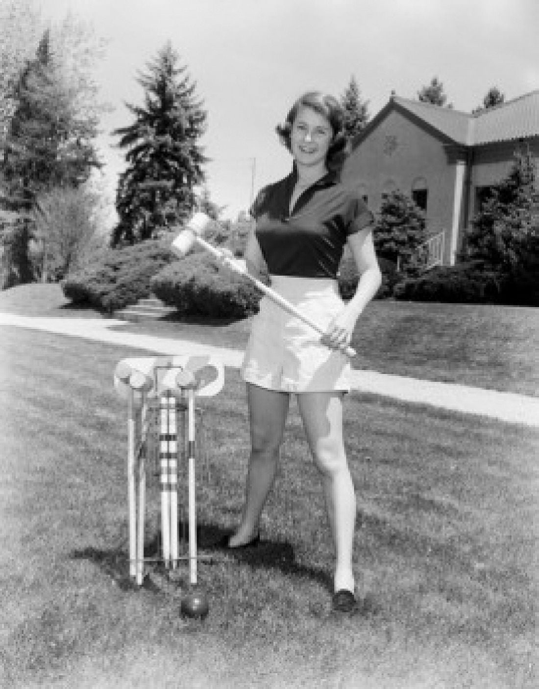 Young woman standing on lawn holding croquet mallet Canvas Art - (18 x 24)