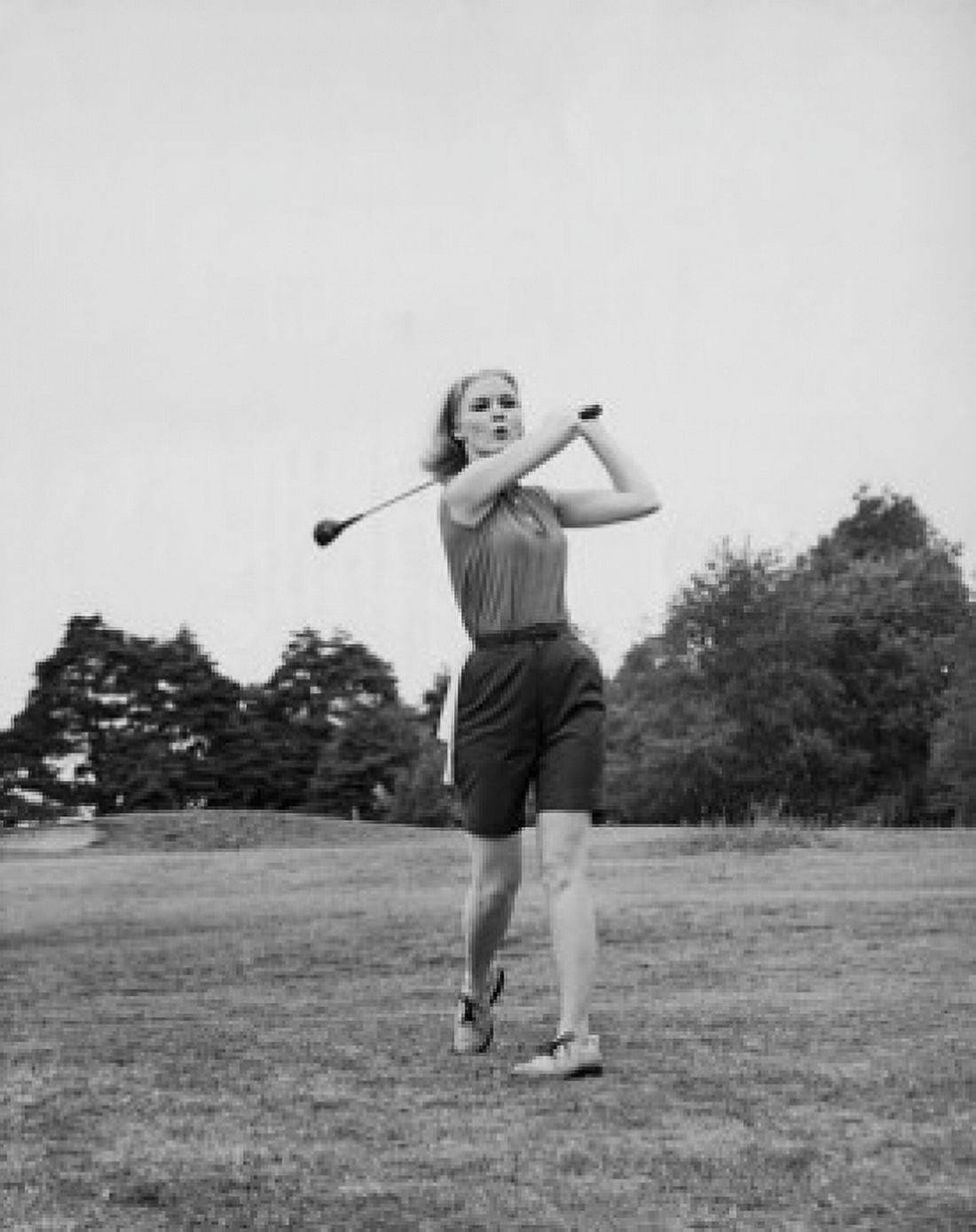 Young woman swinging golf club on golf course Canvas Art - (18 x 24)