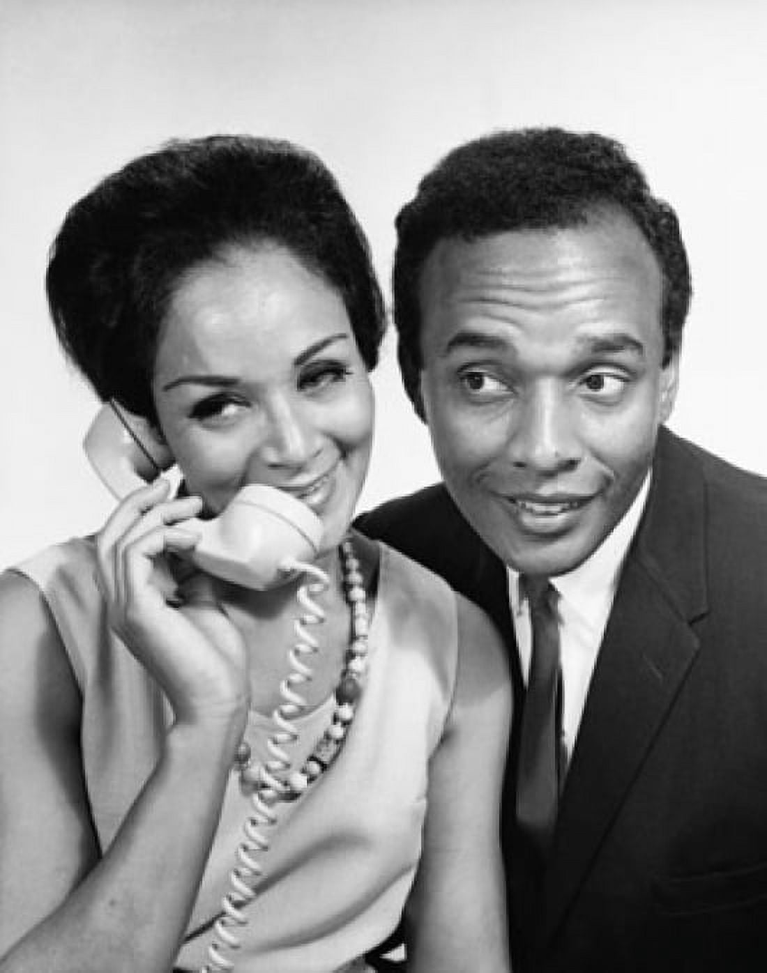 Young woman talking on the telephone with a young man beside her Canvas Art - (24 x 36)