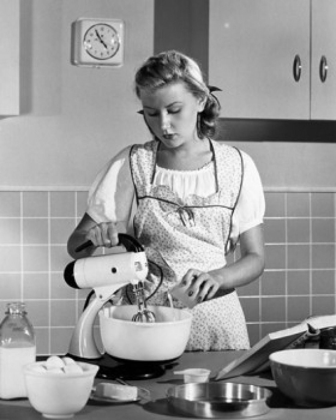 Young woman using an egg beater in a domestic kitchen Canvas Art - (24 x 36)