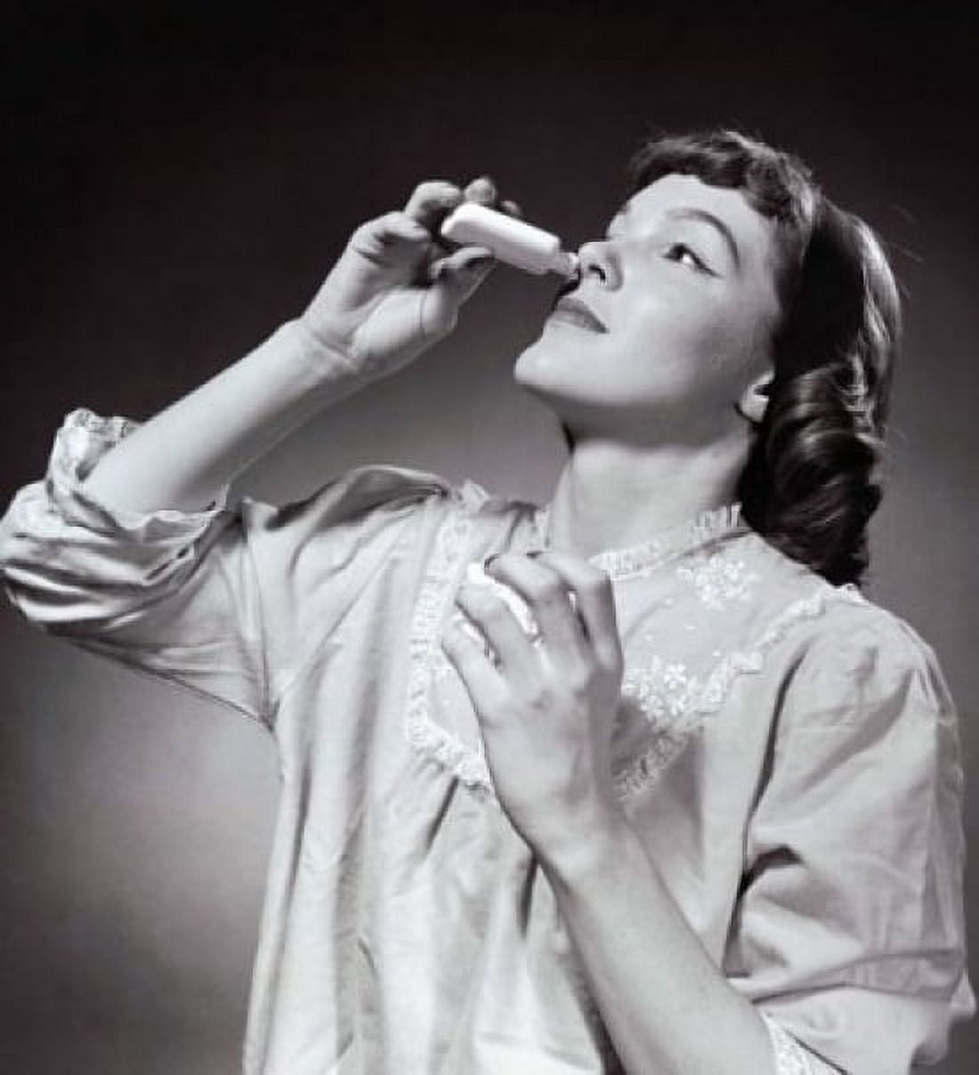 Young woman using nasal spray Canvas Art - (24 x 36)