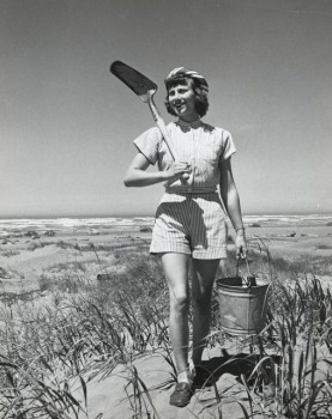 Young woman walking on the beach and carrying sand pail and shovel Long Beach Washington USA Canvas Art -  (18 x 24)