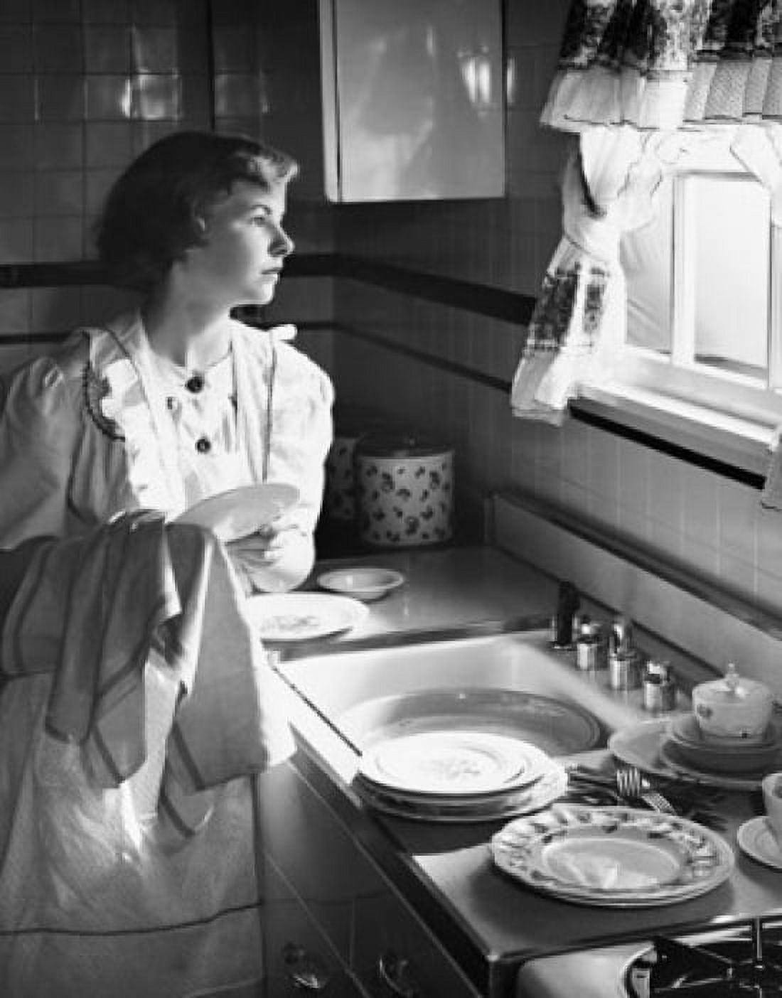 Young woman washing dishes and looking out window Canvas Art - (24 x 36)