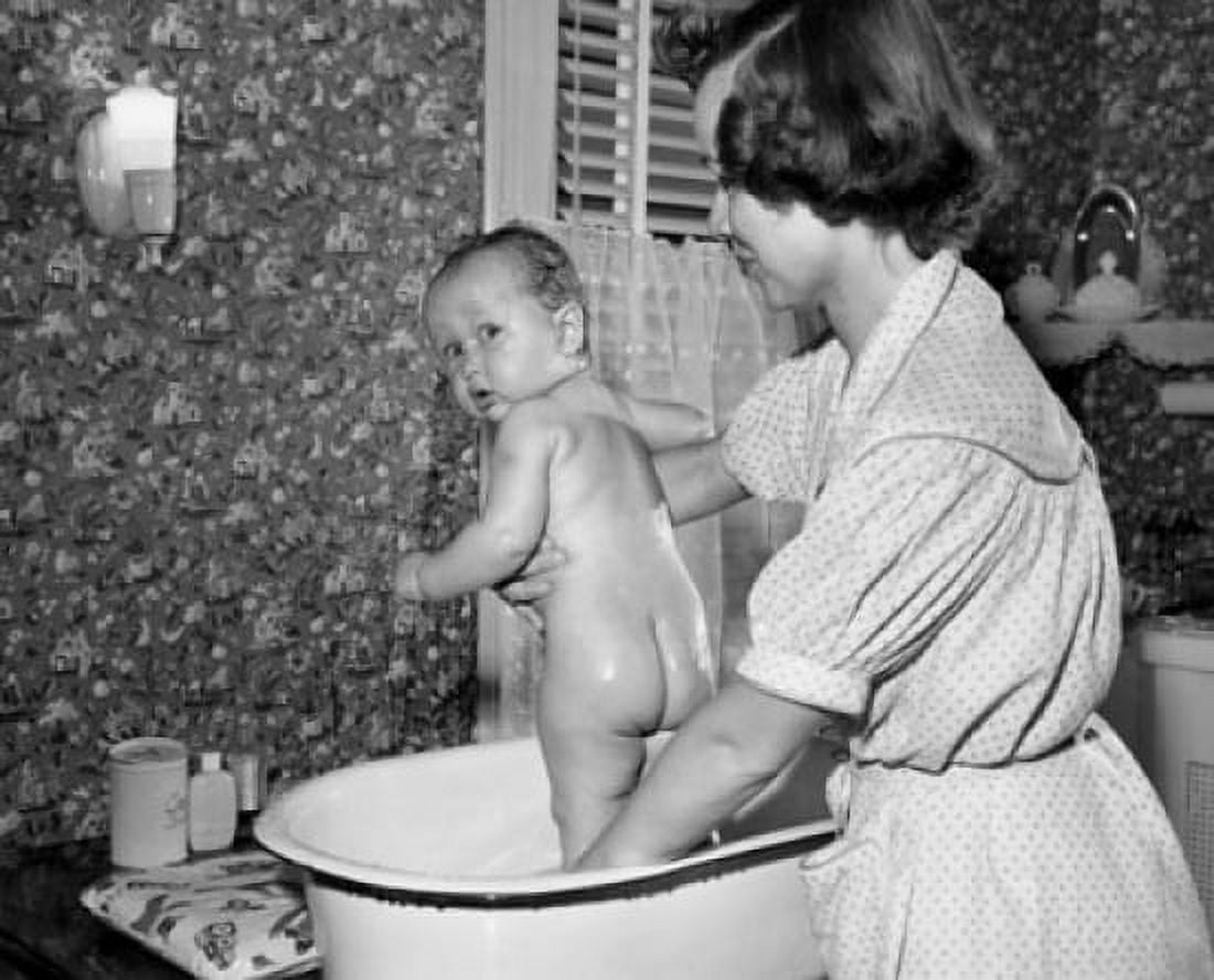 Young woman washing her baby in a washtub Canvas Art - (18 x 24)