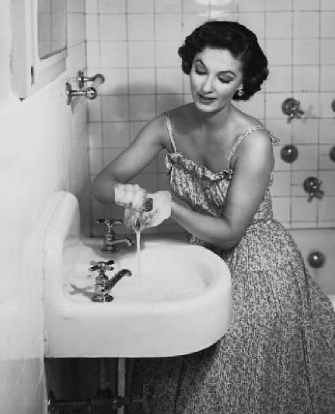 Young woman washing her hands in the bathroom sink Canvas Art -  (24 x 36)