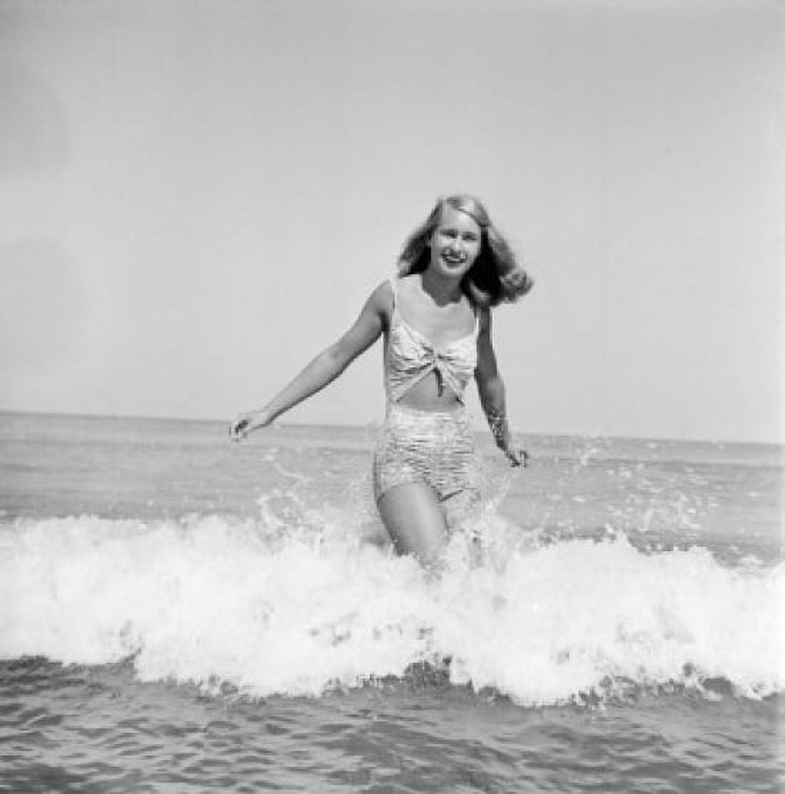 Young woman wearing bikini wading in sea Canvas Art - (24 x 36)