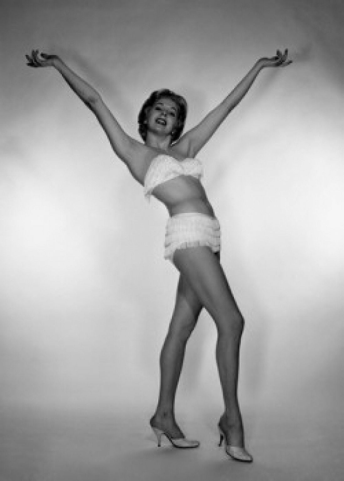Young woman wearing bikini with raised hands studio shot Canvas Art - (18 x 24)