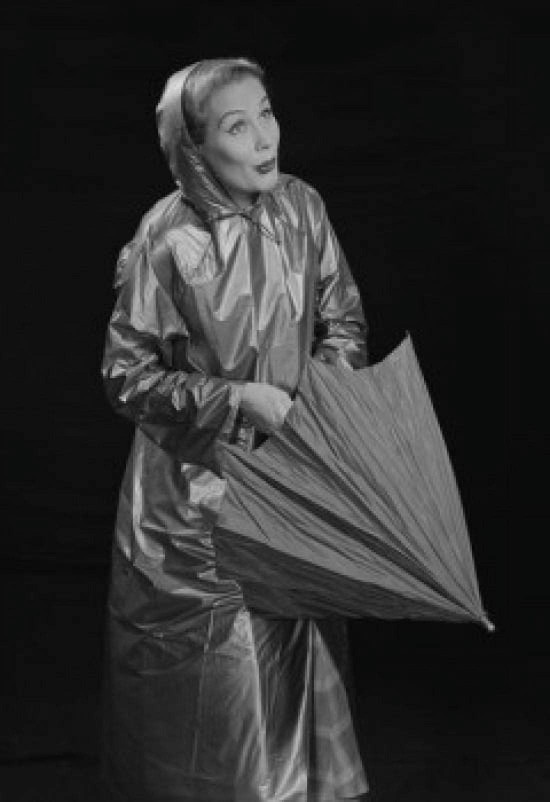 Young woman wearing raincoat opening umbrella Canvas Art - (18 x 24)