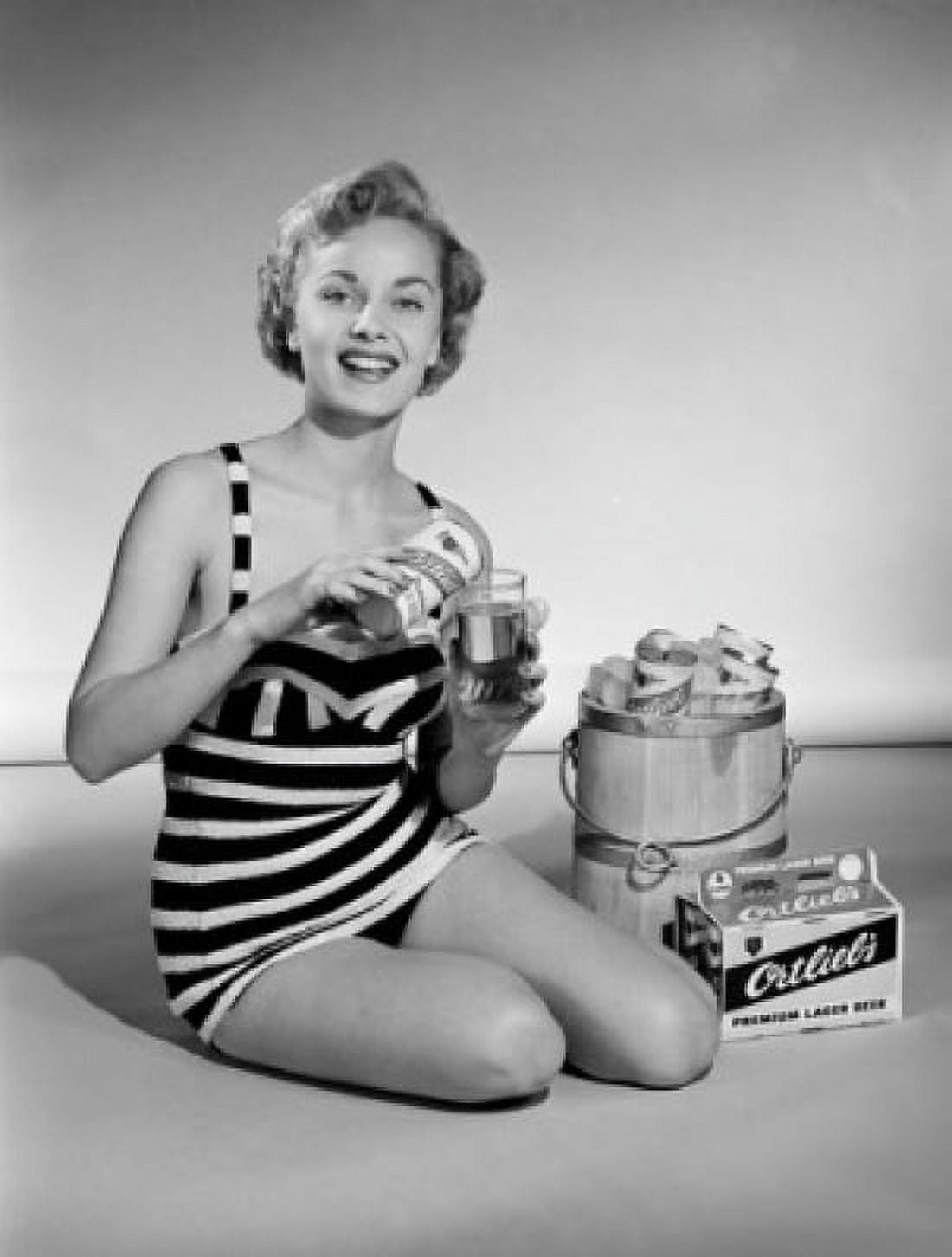 Young woman wearing swimsuit pouring beer into glass Canvas Art - (18 x 24)