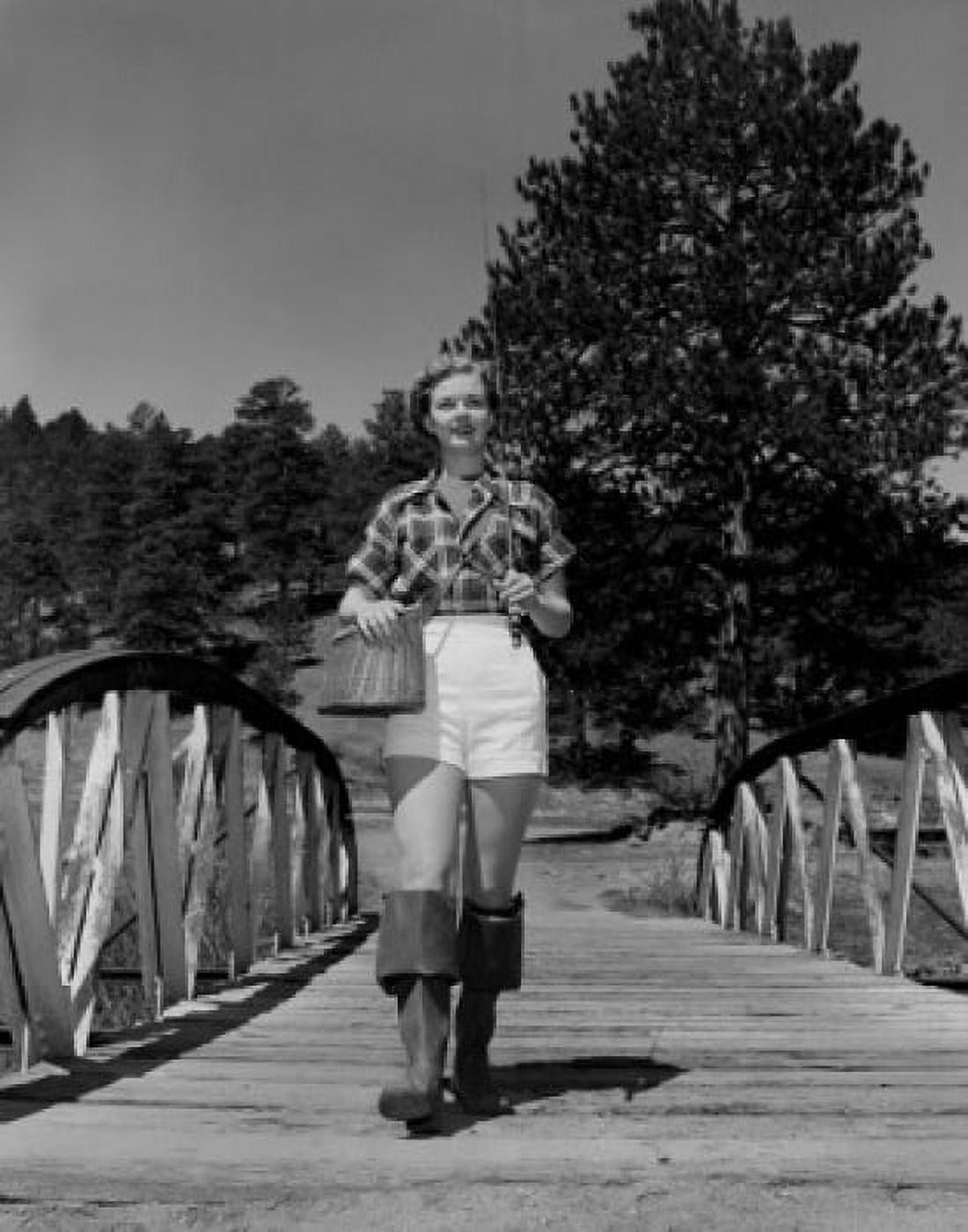 Young woman wearing wellingtons carrying fishing rod and basket Canvas Art - (24 x 36)